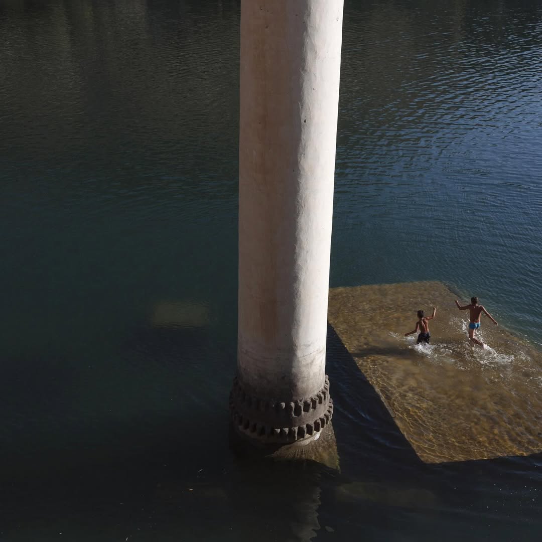 Children play on the roof of a partially sunken mosque in Savasan, Turkey, 2018, by Emin Özmen